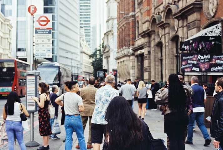 People in London street near a bus stop. Credit: Unsplash.
