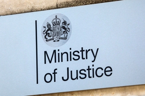  Ministry of Justice sign with the UK royal coat of arms mounted on an exterior building wall
