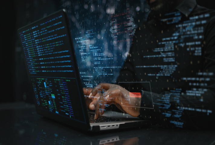 Hands of male sitting in front of the computer 