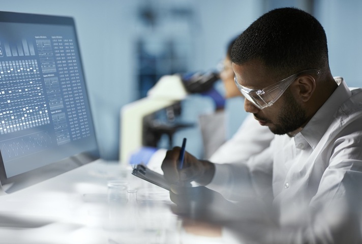 Scientist in lab working on a computer. Credit: iStock Photo