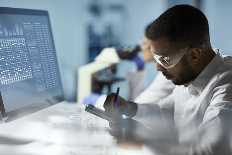 Scientist in lab working on a computer. Credit: iStock Photo