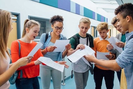 Students looking happy, receiving their exam results