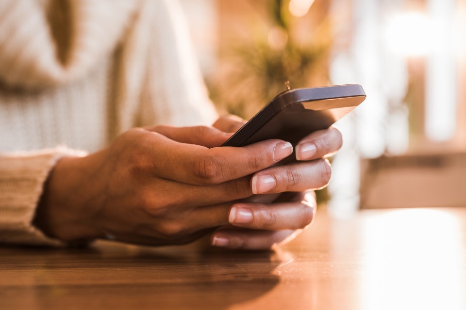 Hands using a mobile phone