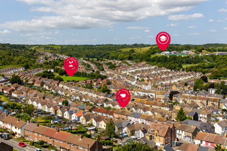 An aerial photograph of houses, with digital map markers to symbolise UPRNs and other data