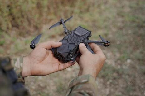 Close up of a soldier holding a drone