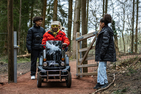 A family using an accessible path in a woodland