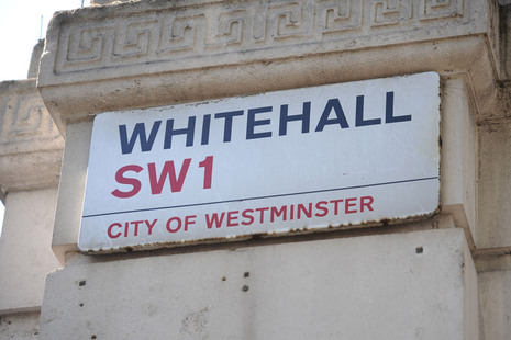 Street nameplate on a stone building corner reading "Whitehall"