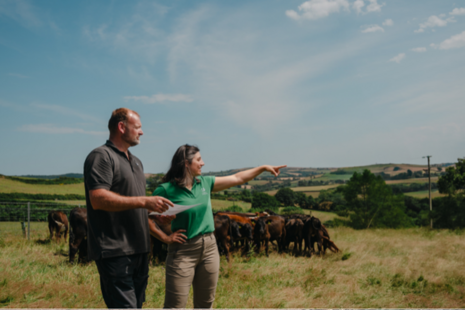 A Forestry Commission advisor with a farmer in a cattle field