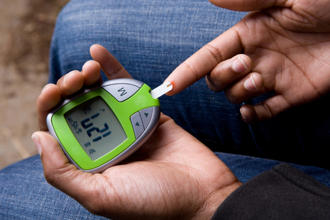 Person using a blood sugar monitor